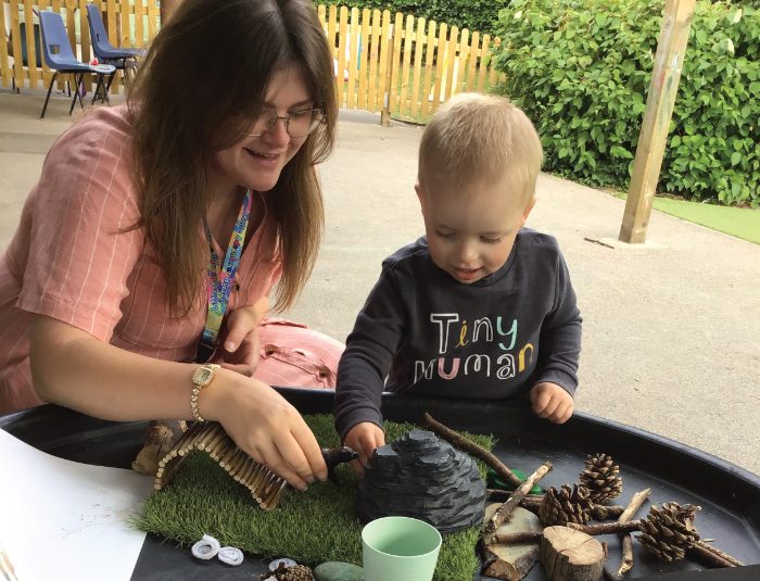 Little Adventures Nursery Lucy engaging with a children with a sensory table